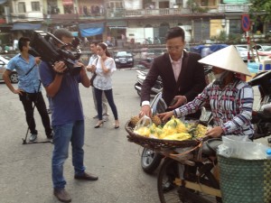 Interviewing a Hanoi fruit vendor who struggles to support her family.
